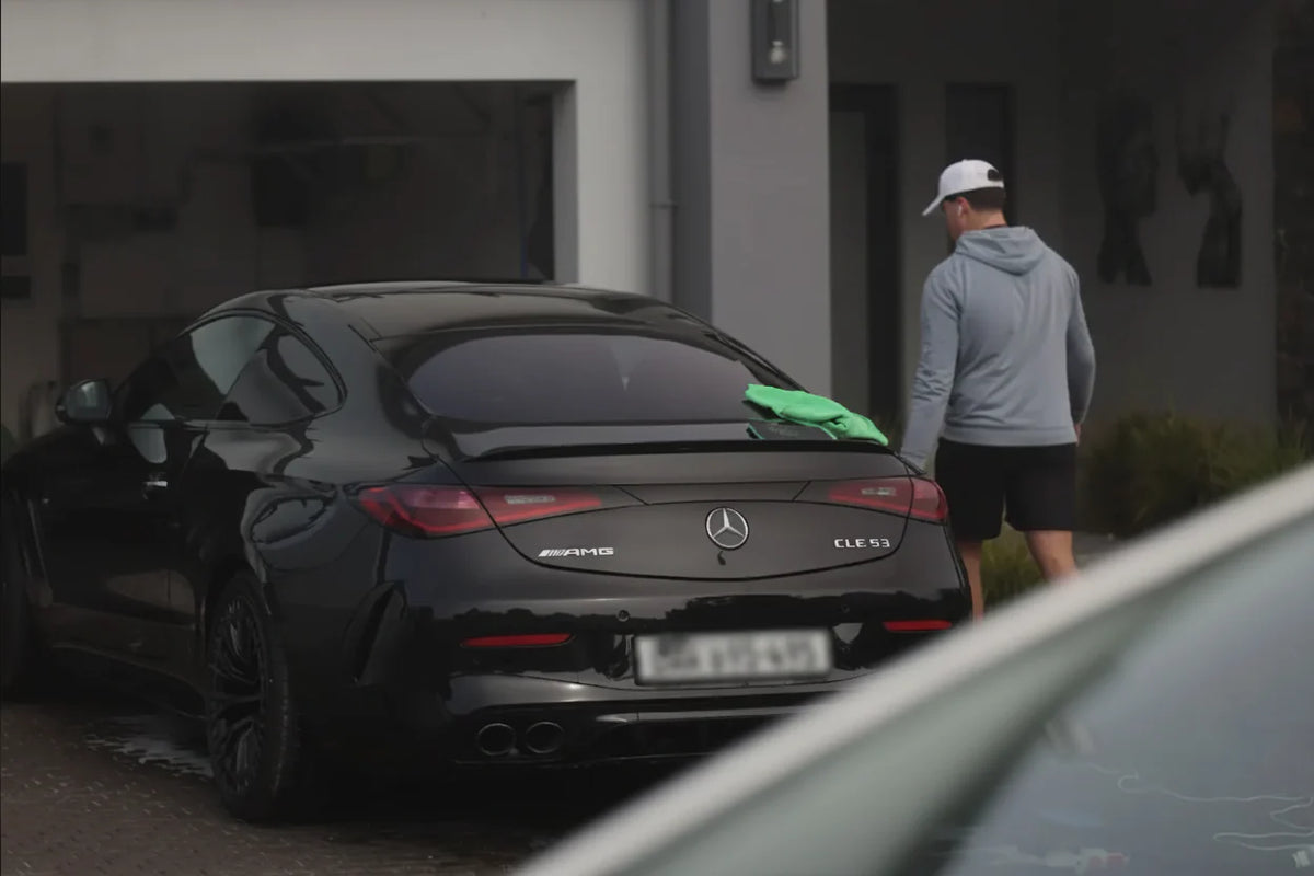 Glossed detailing a black Mercedes-AMG at a client location